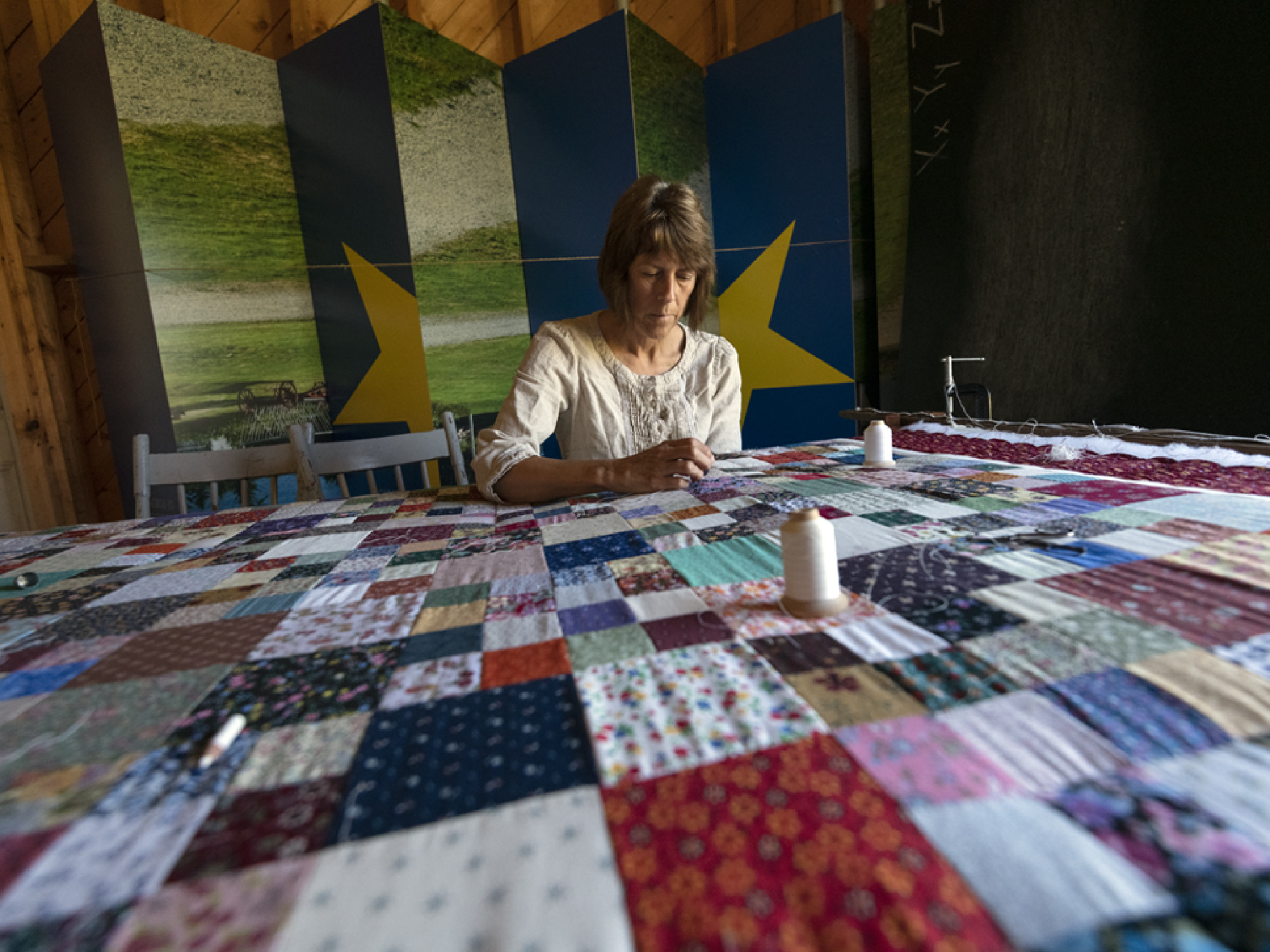 Costumed interpreter quilting at Le Village Historique Acadien de la Nouvelle-Écosse