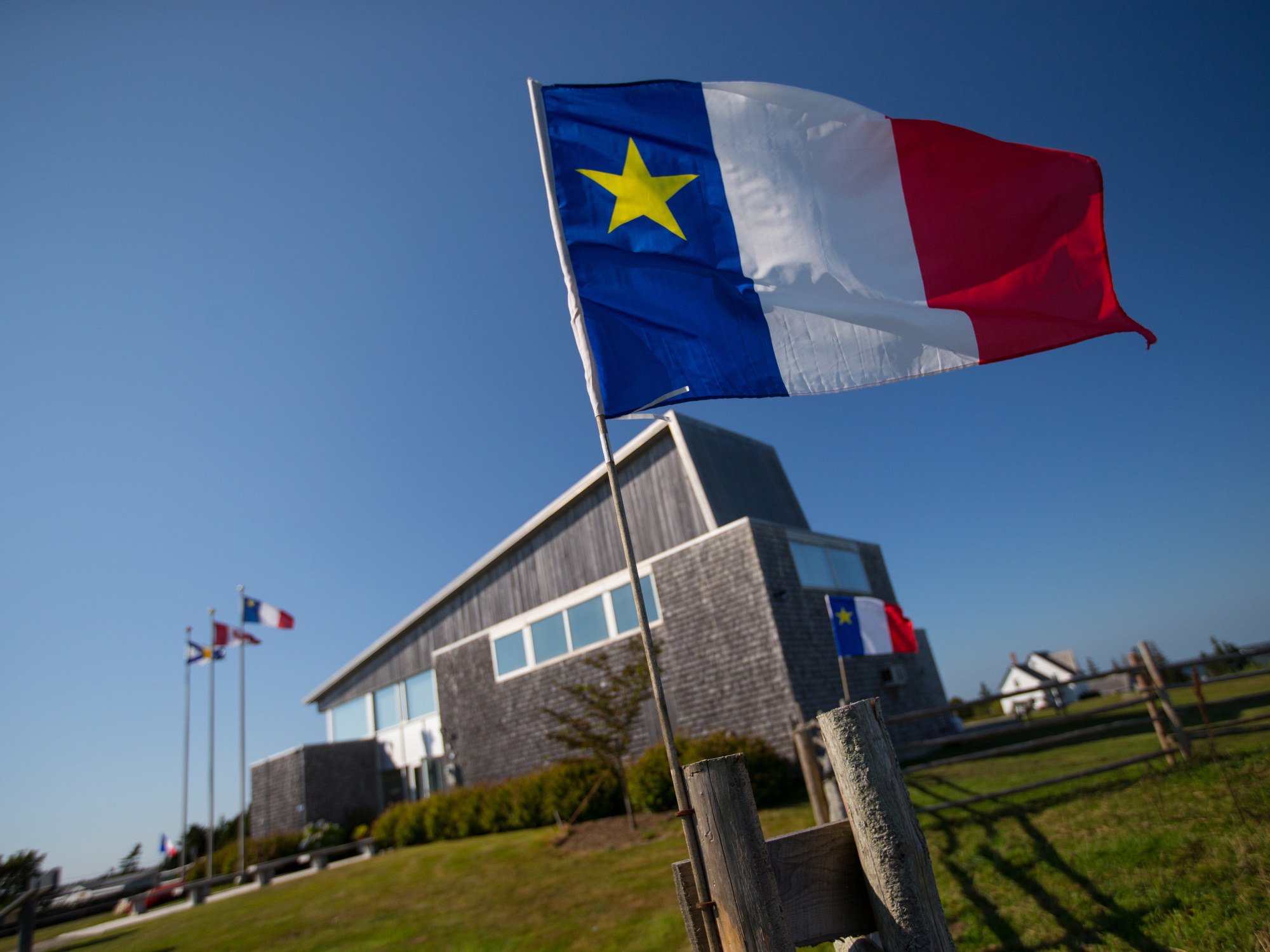 The Acadian Flag flying in front of the Visitor Reception and Administration Centre.